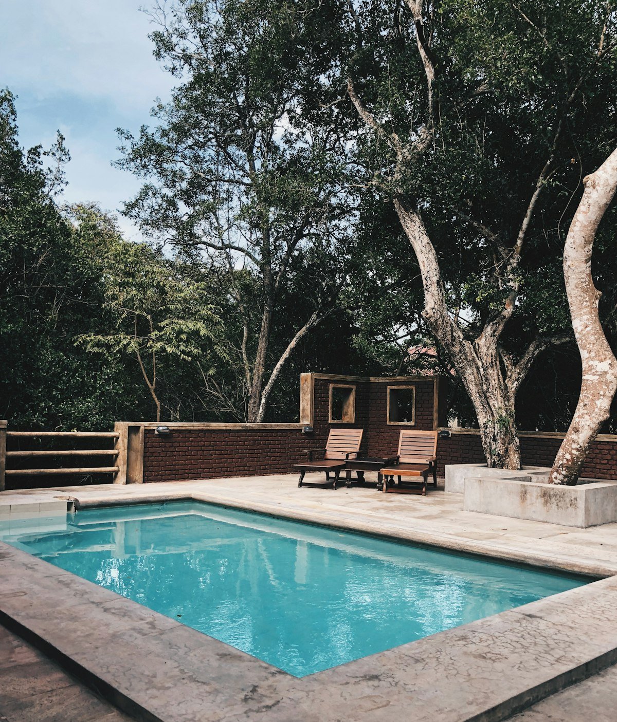 Poolside lounge chairs at a maintained Houston pool